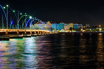 Assorted-color Buildings Near Body of Water at Night