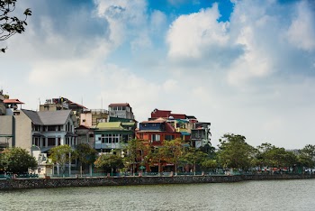 Assorted-color Buildings Near Water and Trees
