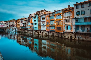 Assorted-color Concrete Buildings Beside River at Daytime