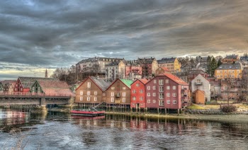 Assorted-color Concrete Buildings Near Body of Water