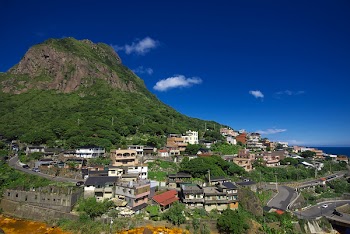 Assorted-color Concrete Buildings Near Mountain