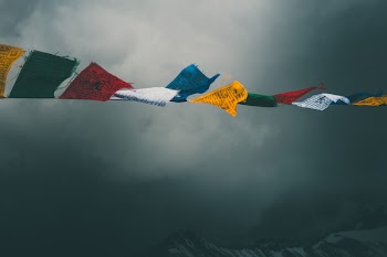 Assorted-color Flags Under Gray Clouds