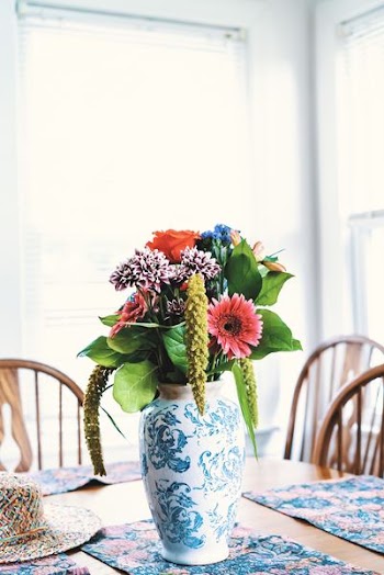 assorted-color flowers centerpiece on green floral mat