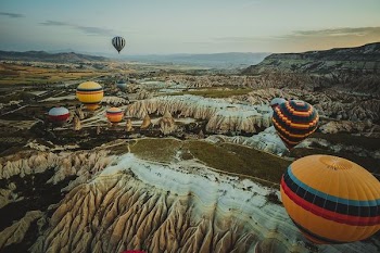 assorted-color hot air balloons on mid-air during orange sunset