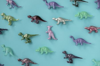 Assorted-color Plastic Dinosaur Figurine Lot on Teal Surface