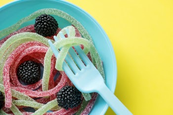 Assorted-colored Jellies on Teal Plastic Bowl