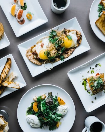 assorted cooked food on white ceramic plates