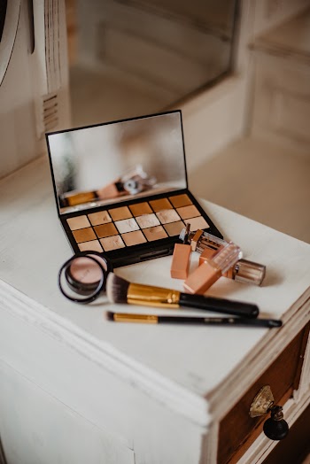 Assorted Cosmetic Products on White and Brown Wooden Drawer Cabinet