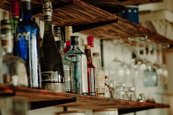Assorted Labeled Bottle on Brown Shelf