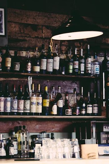 assorted liquor bottles on display shelves