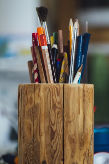 Assorted Pens on Brown Vase