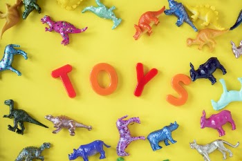 Assorted Plastic Toy on Yellow Surface