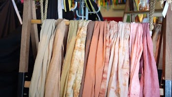 assorted scarves on brown wooden rack