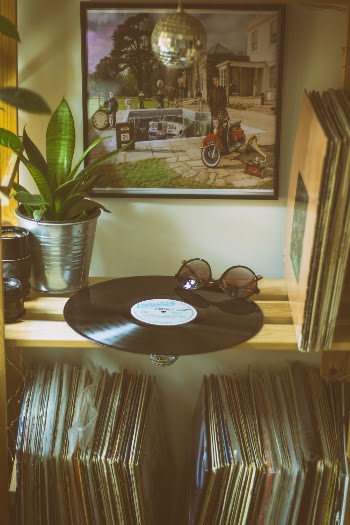 Assorted Vinyl Sleeves on Brown Wooden Rack