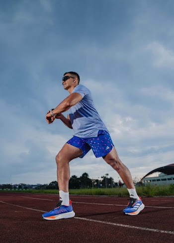 Athlete Preparing for a Sprint on a Track