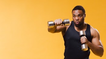 Athletic man exercising with weights Free Photo
