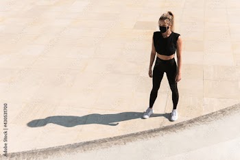 Athletic woman wearing face mask during summer street workout