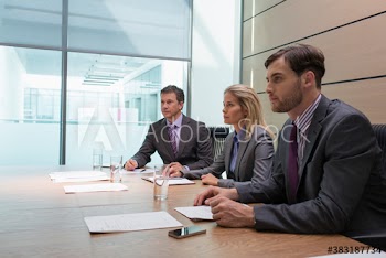Attentive business people listening in conference room meeting