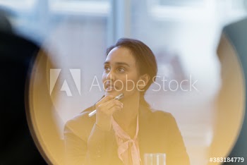 Attentive young businesswoman listening in meeting
