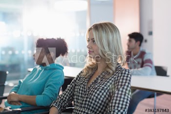 Attentive young female college student listening in classroom