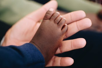 Baby's Right Foot on Person' Left Palm