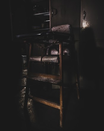 Baby's Wooden Highchair in Dim Light