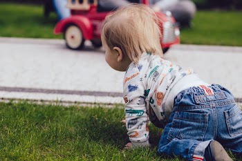 Baby boy crawling outdoors