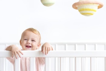 Baby girl in her crib | Free Photo - rawpixel