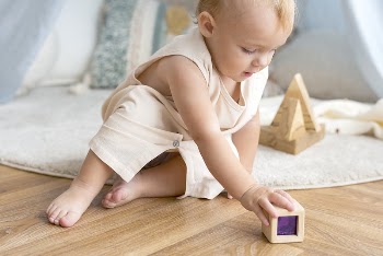 Baby girl playing with a wooden | Free Photo - rawpixel