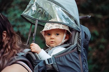 baby inside black backpack carrier