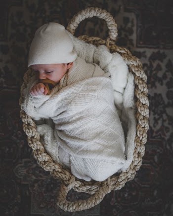 baby lying on basket