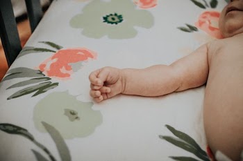 baby lying on bed