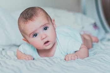 Baby Lying on Bed