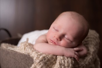 Baby Lying On Beige Knit Textile