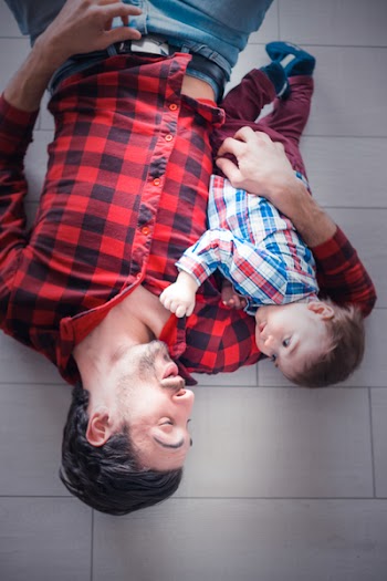 Baby Lying on Man's Arm