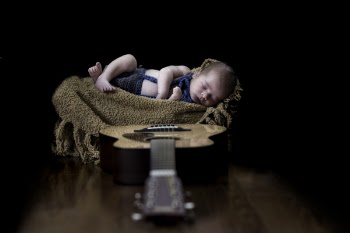 Baby on Beige Textile Near Brown Dreadnought Acoustic Guitar