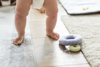 Baby Walking Towards Round Gray Toy