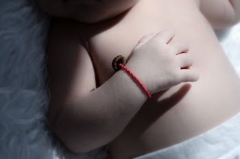 Baby Wearing Red Bracelet