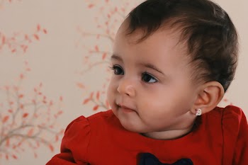 Baby Wearing Red Crew-neck Shirt Near Pink and Black Floral Surface
