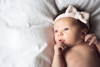 Baby Wearing White Fabric Headband With Bow Accent