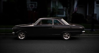 Back Coupe Parked on Asphalt Road Near Basketball Hoop