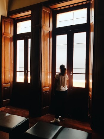 Back View Of A Girl Standing   The Wood And Glass Door