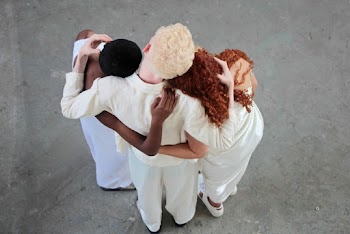 Back view of a Man Hugging Two Women