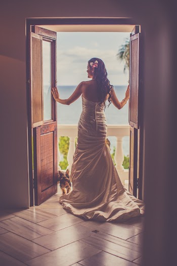 Back View Of A Woman In A Wedding Gown Standing On The Doorway Leading To A Balcony
