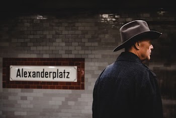 Back View Of Man Wearing Cowboy Hat and Black Coat