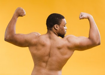 Back view of shirtless athletic man biceps Free Photo