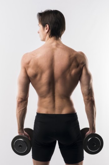 Back view of shirtless athletic man holding weights Free Photo