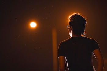 Back View Photo of Man in Glasses Posing During Night