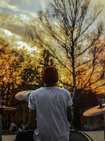 Back View Photo of Man Playing Drums During Golden Hour