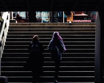Back view Photo of Two Woman Walking up Stairs